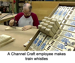 A Channel Craft employee makes train whistles